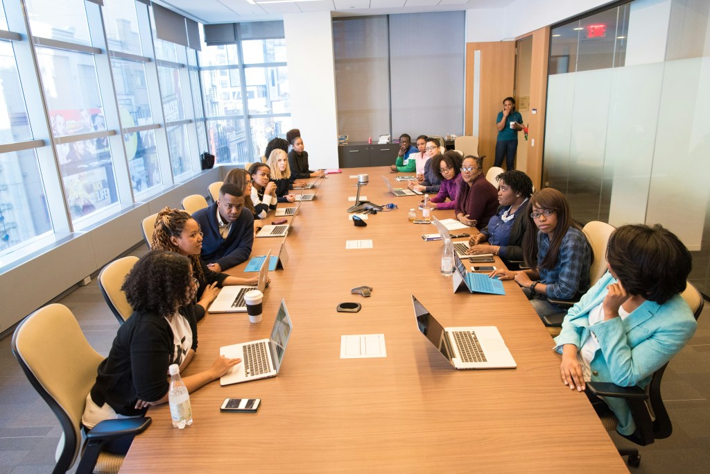A colleague focused on her laptop during a collaborative work session