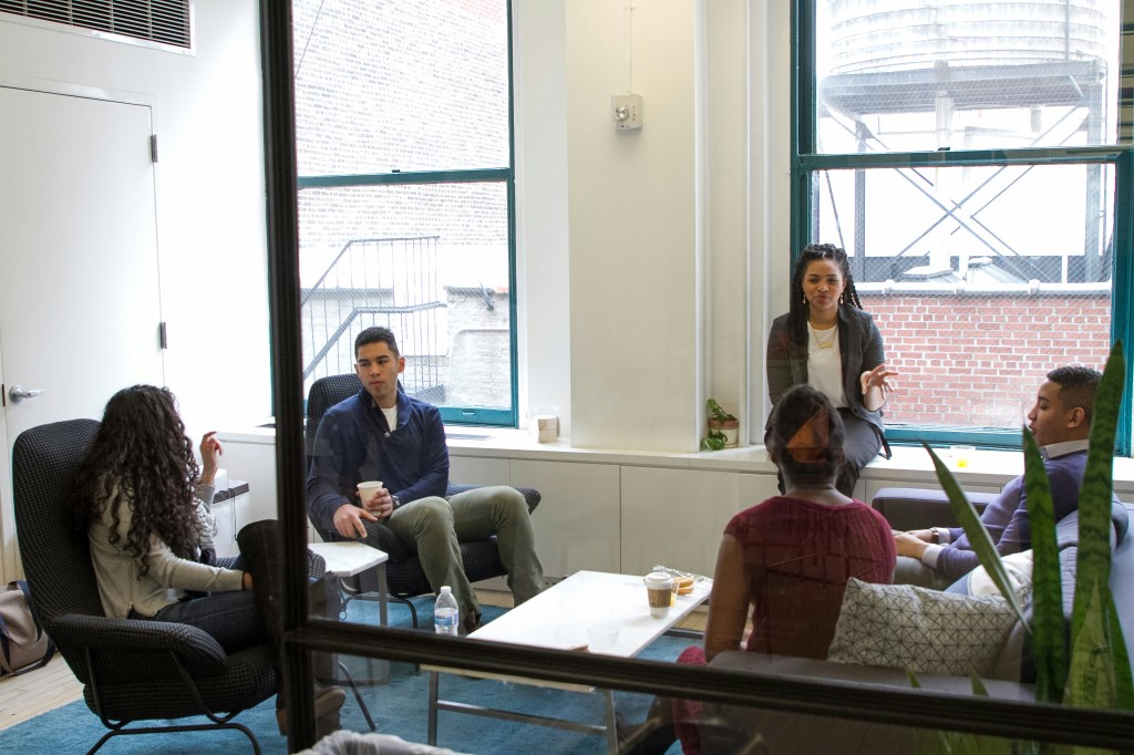 Diverse team of colleagues collaborating together in a bright, modern workplace