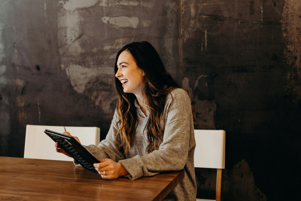 Smiling professional seated at a table